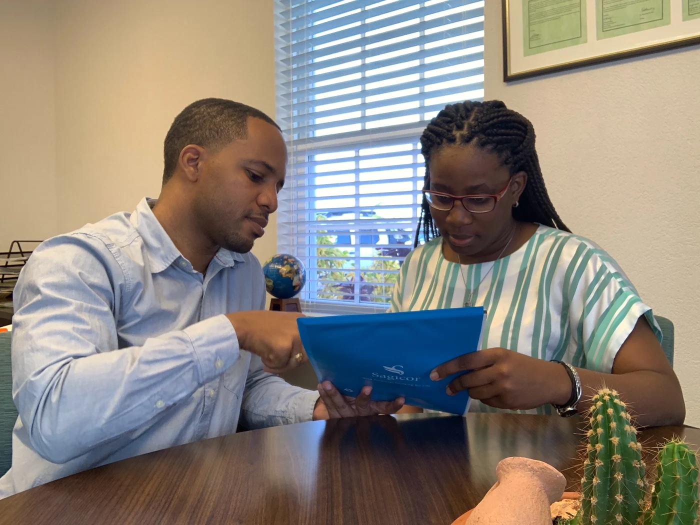 Jamar and a client looking through a blue folder