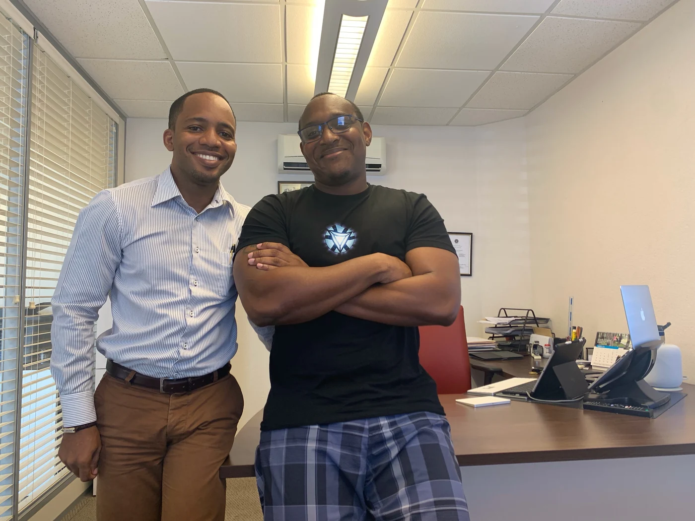 Jamar standing beside a client at BIAI