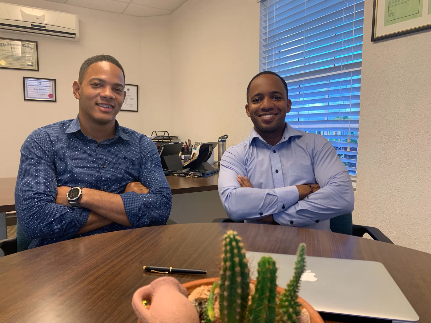 Jamar and a client seated at the office table