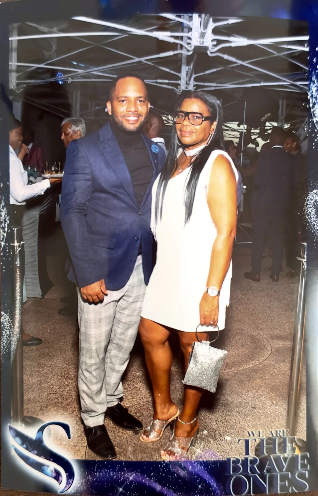 Jamar and a woman in white at an event photo frame