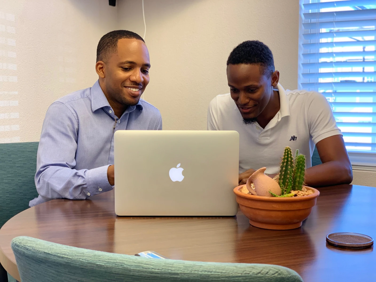 Jamar and a client sharing a conversation at a laptop
