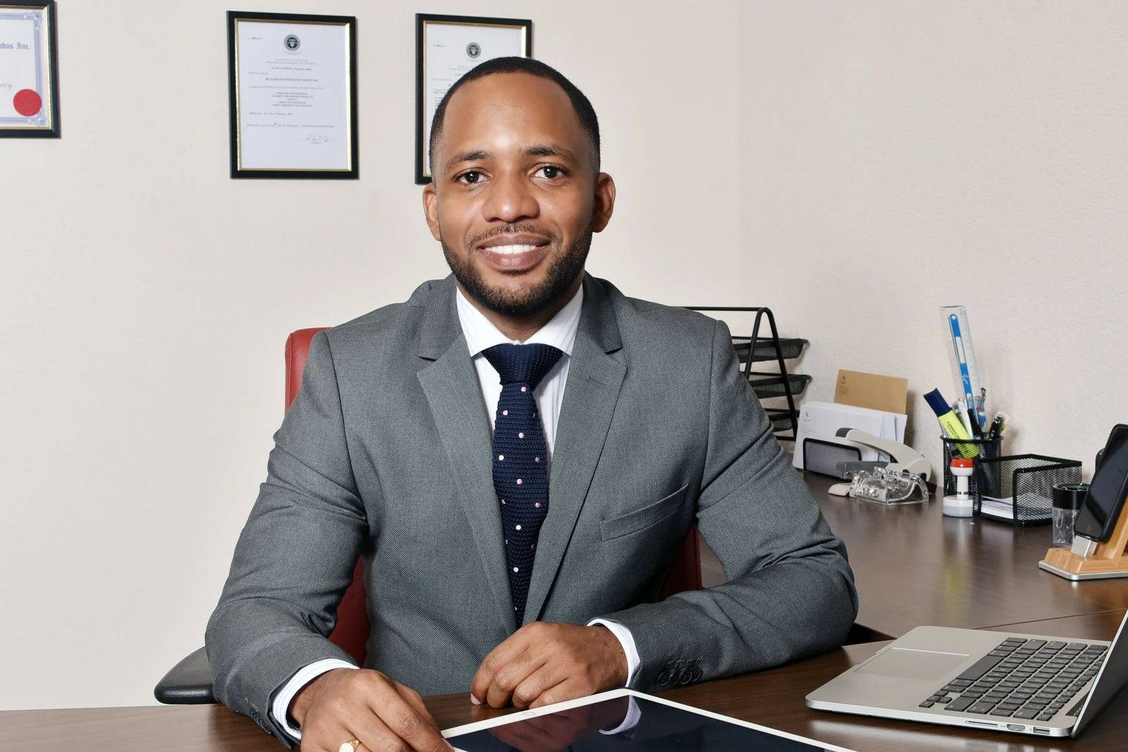 Jamar Blackman, LUTCF, FSCP, seated at his office desk
